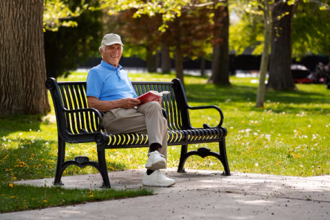 senior-man-sitting-bench-outdoors-reading-book_23-2150579745