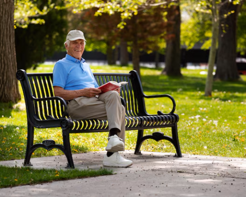 senior-man-sitting-bench-outdoors-reading-book_23-2150579745